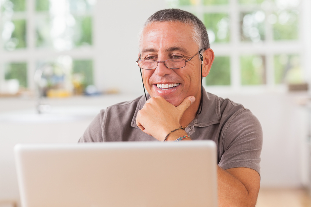 Smiling man at laptop