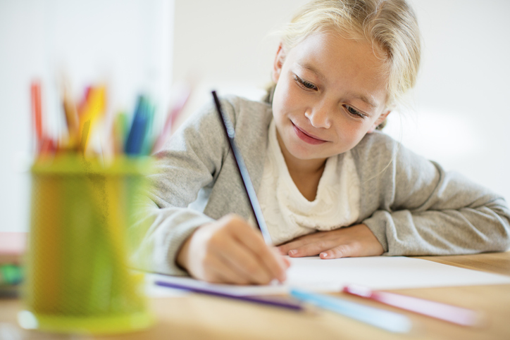 girl with autism writing on paper