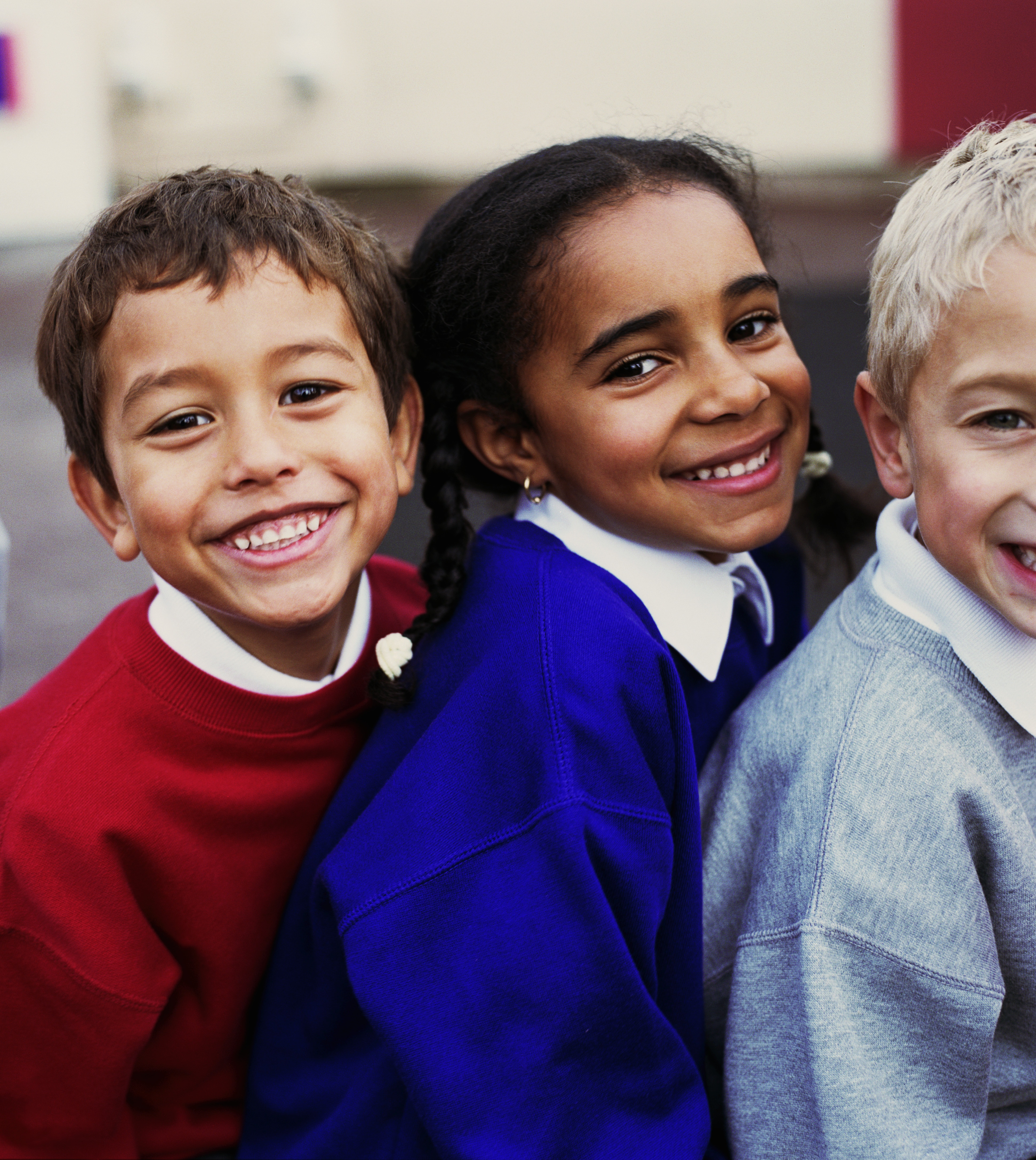 autistic child with friends smiling together