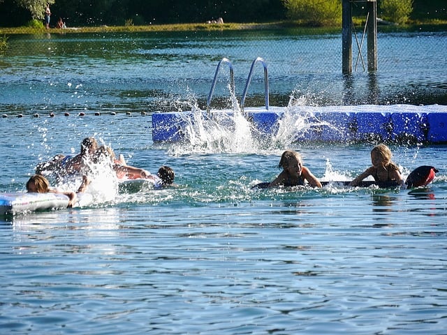 autistic child swimming with friends at camp