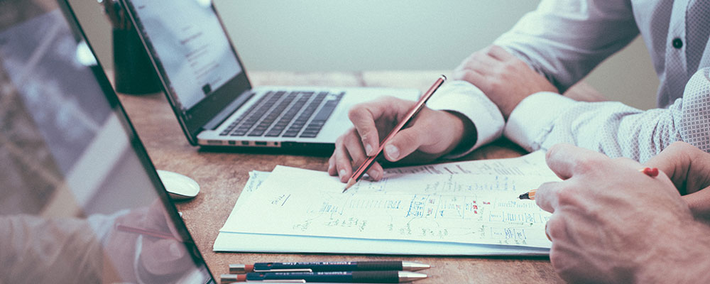 resources-library-featured-image-a-hand-pointing-a-pencil-at-a-list-on-a-desk