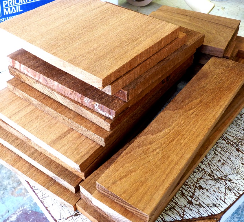 Stacked planks of teak lumber