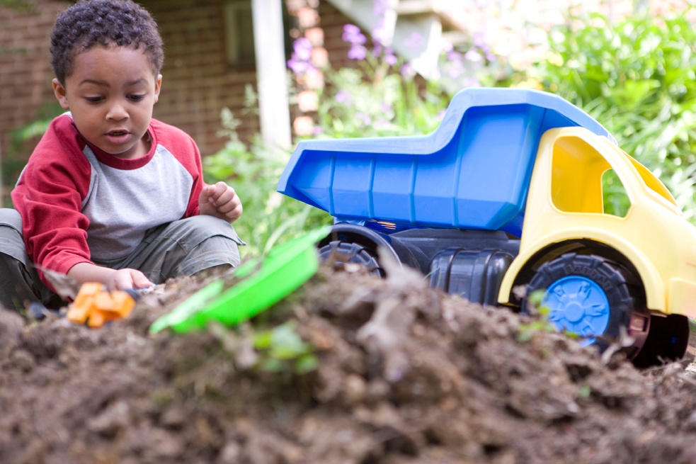 2009 Dawn Arlotta Description: This young African-American boy was have a fun, imaginative time play with his toys in a backyard sandpile. Children love playing outside, and this child was thoroughly enjoying his this time having fun in the fresh outdoor air, and the beautiful weather.It is important to know that sunscreen should be applied on any exposed skin, and children should wear clothing appropriate for this kind of outdoor play including sneakers, shirts, and long pants, all of which protect the children from splinters, and abrasions. It’s also a good idea to have children play in groups rather than alone, not only to improve safety, but for the purpose of cultivating friendships as well. It is also important to note that proper handwashing is a must after playing in any outdoor environment, thereby, removing contaminants from the skin surface, including viruses such as H1N1.Keywords: Sunblock Physical activity; Asthma attack; Black; H1N1