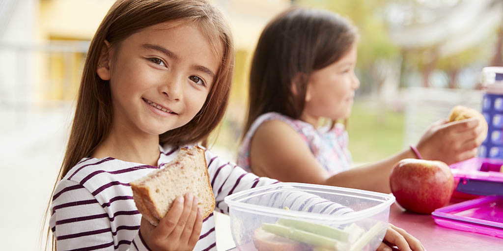 elementary-school-girls-eating-at-school-lunch