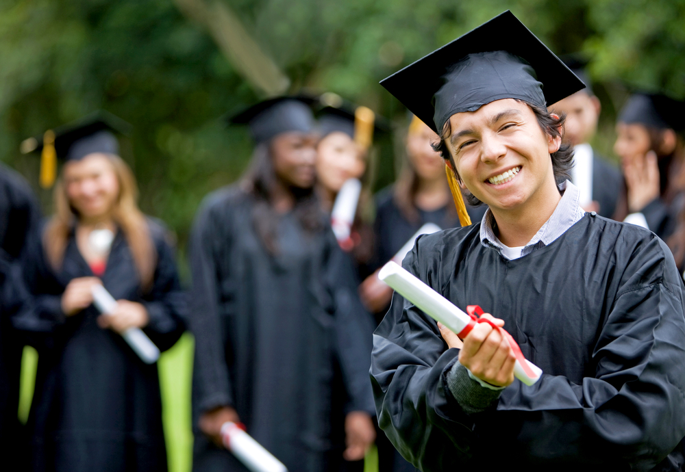 graduation group of students with a man leading smiling