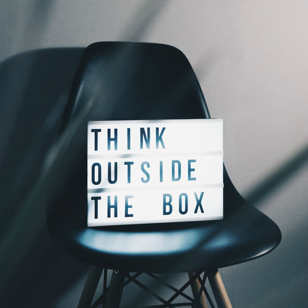 Chair with a Sign that Says “Think Outside the Box” | SupportingStrategiesFranchise.com