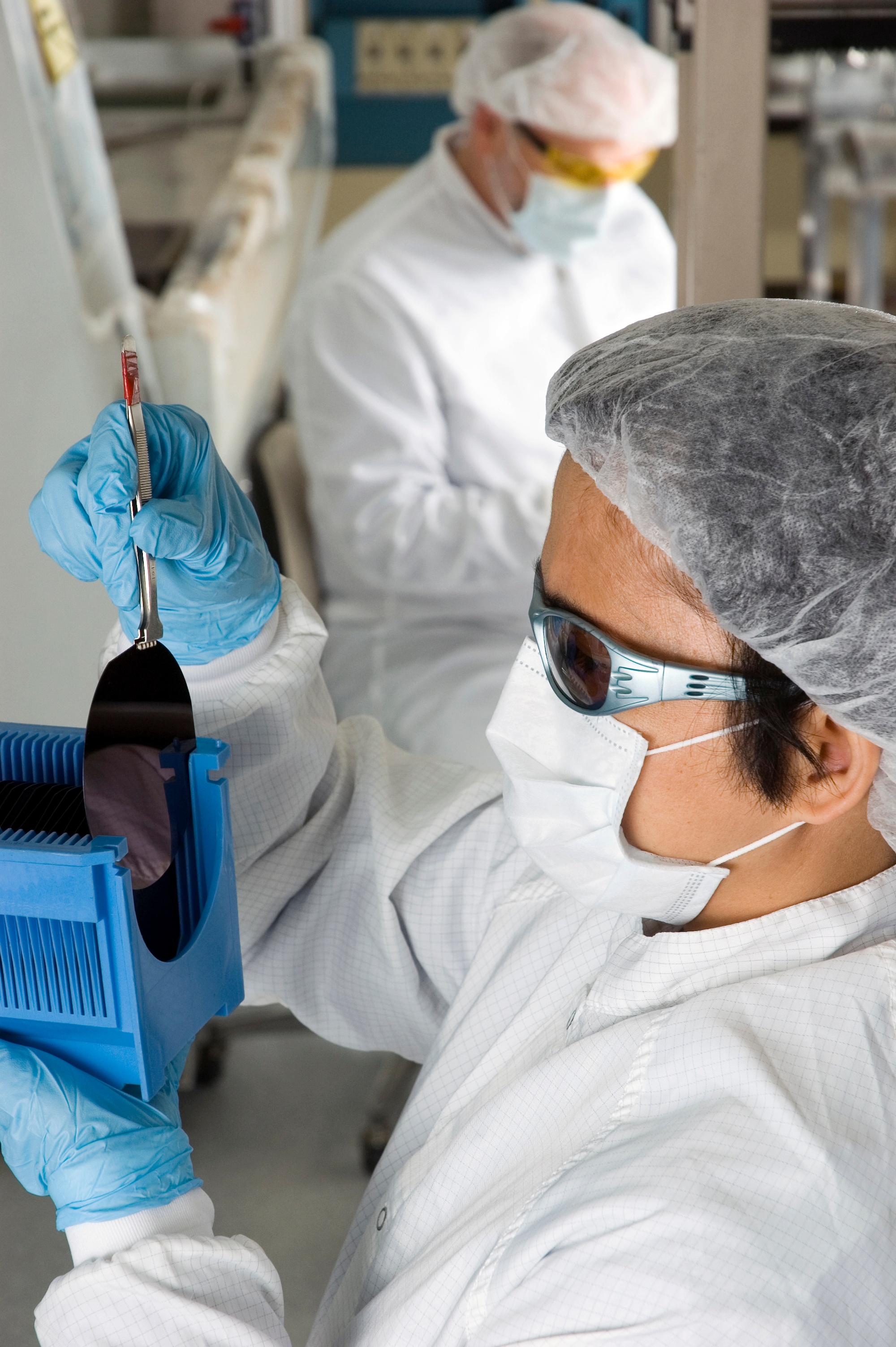 Lab-Technician-Inspecting-a-Silicon-Wafer--Series-000002529634_Large.jpg
