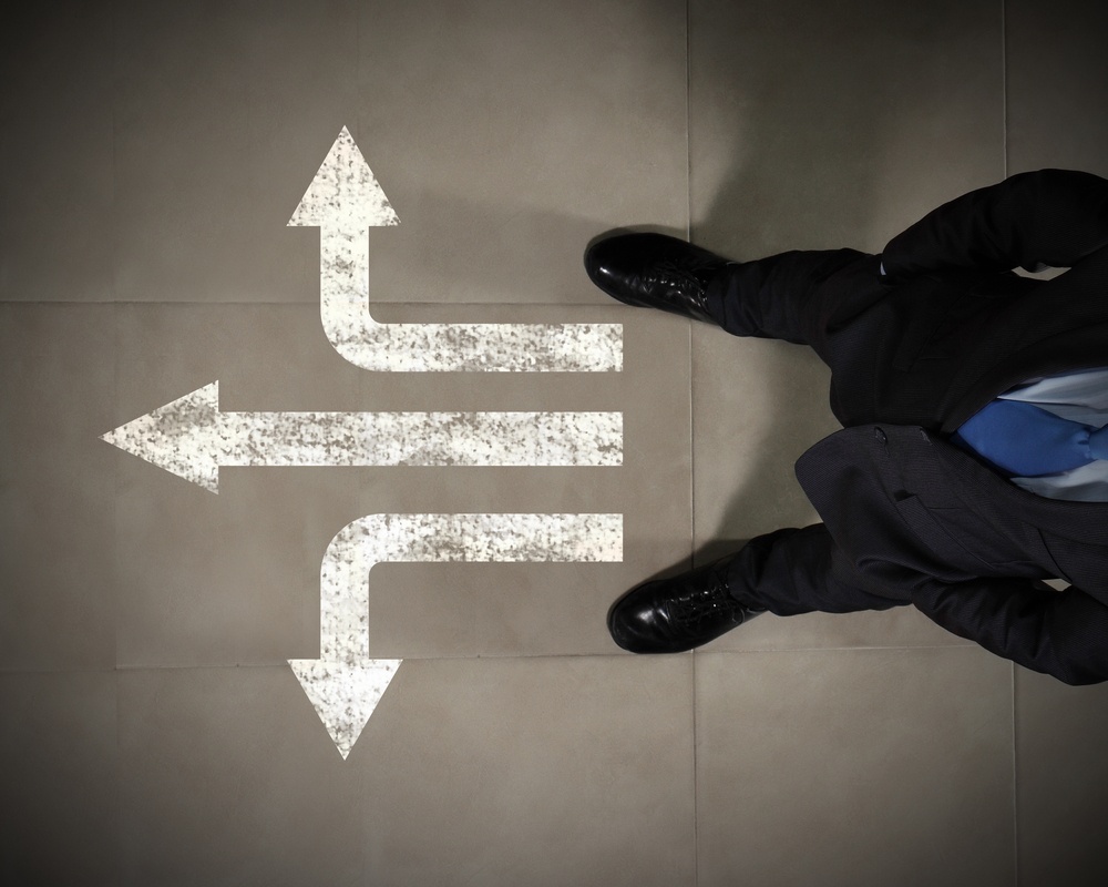 Top view of businessman standing against directions background