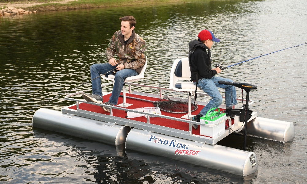 Young Man in Inflatable Boat with Fishing at River. Stock Photo