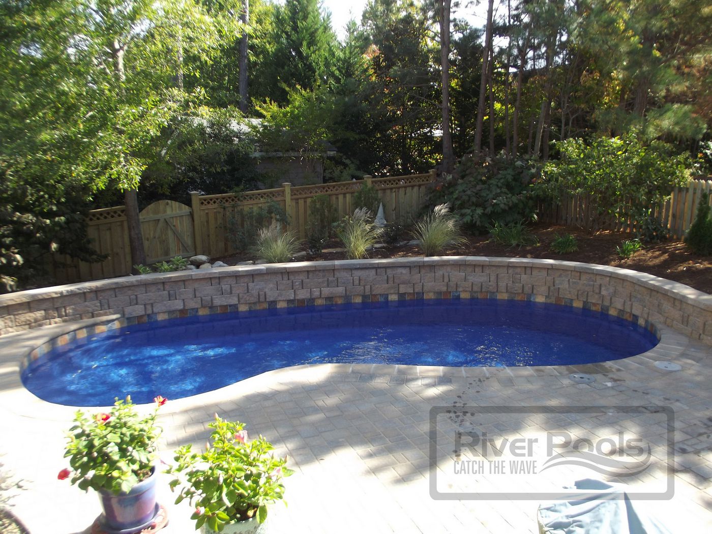fiberglass pool with retaining wall