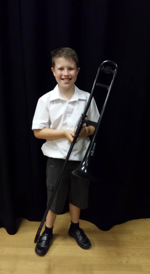 Ethan with his pBone at the Orchestra Concert July 2019