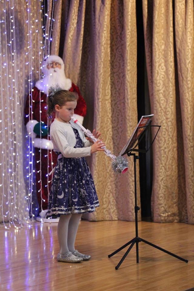 A child playing music in a concert.