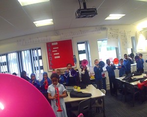 GoPro footage of a music lesson with plastic brass instruments.