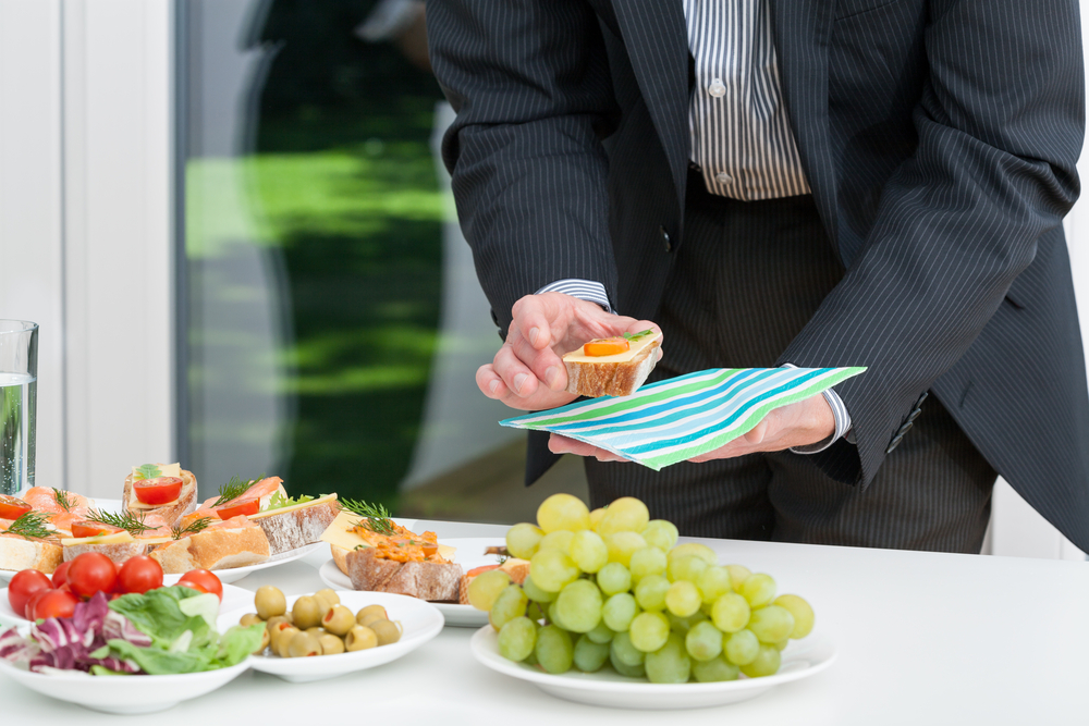 Business lunch and businessman holding colorful snack