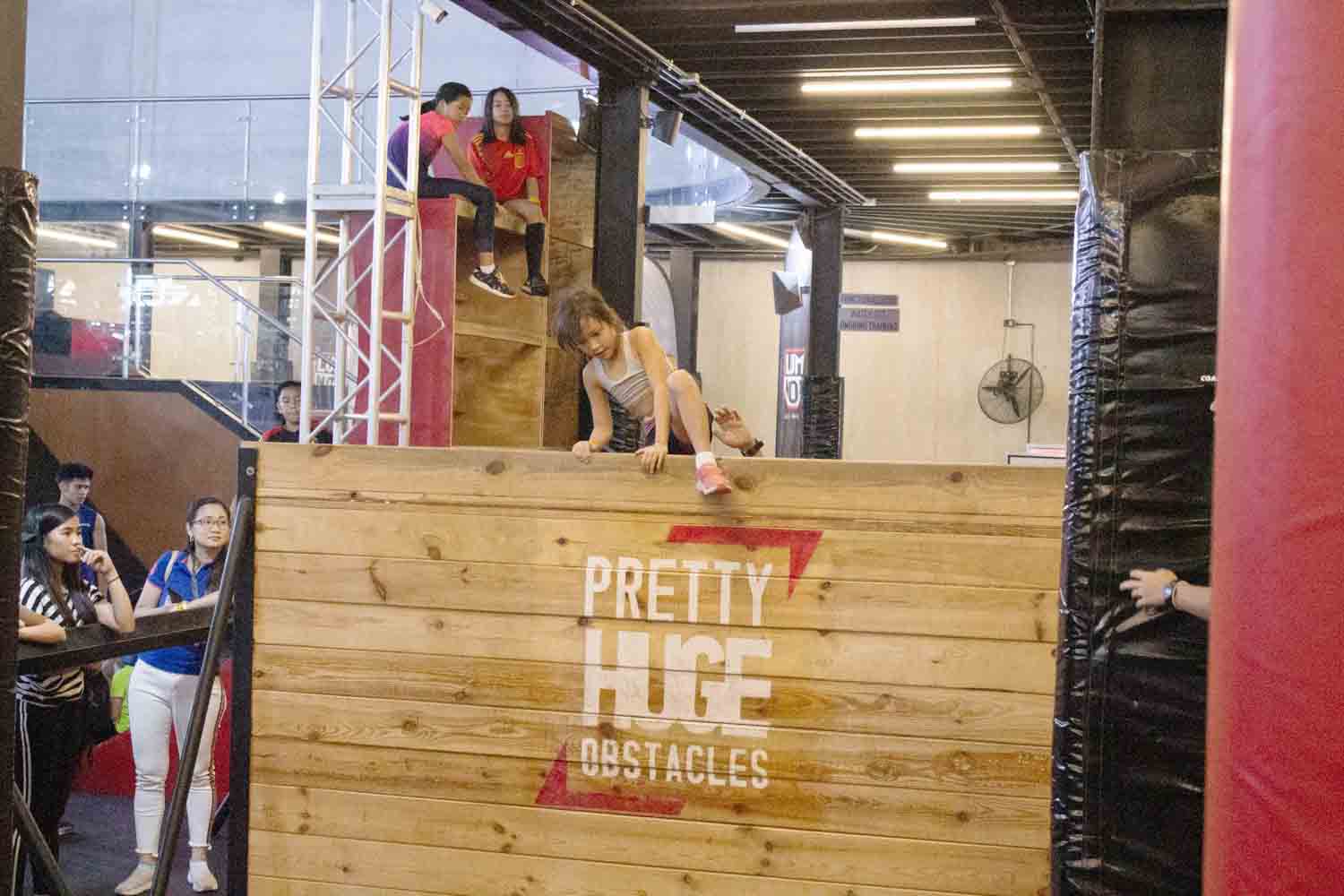 Girl going over wall obstacle at PHO_Fun Exercises for Healthier Kids