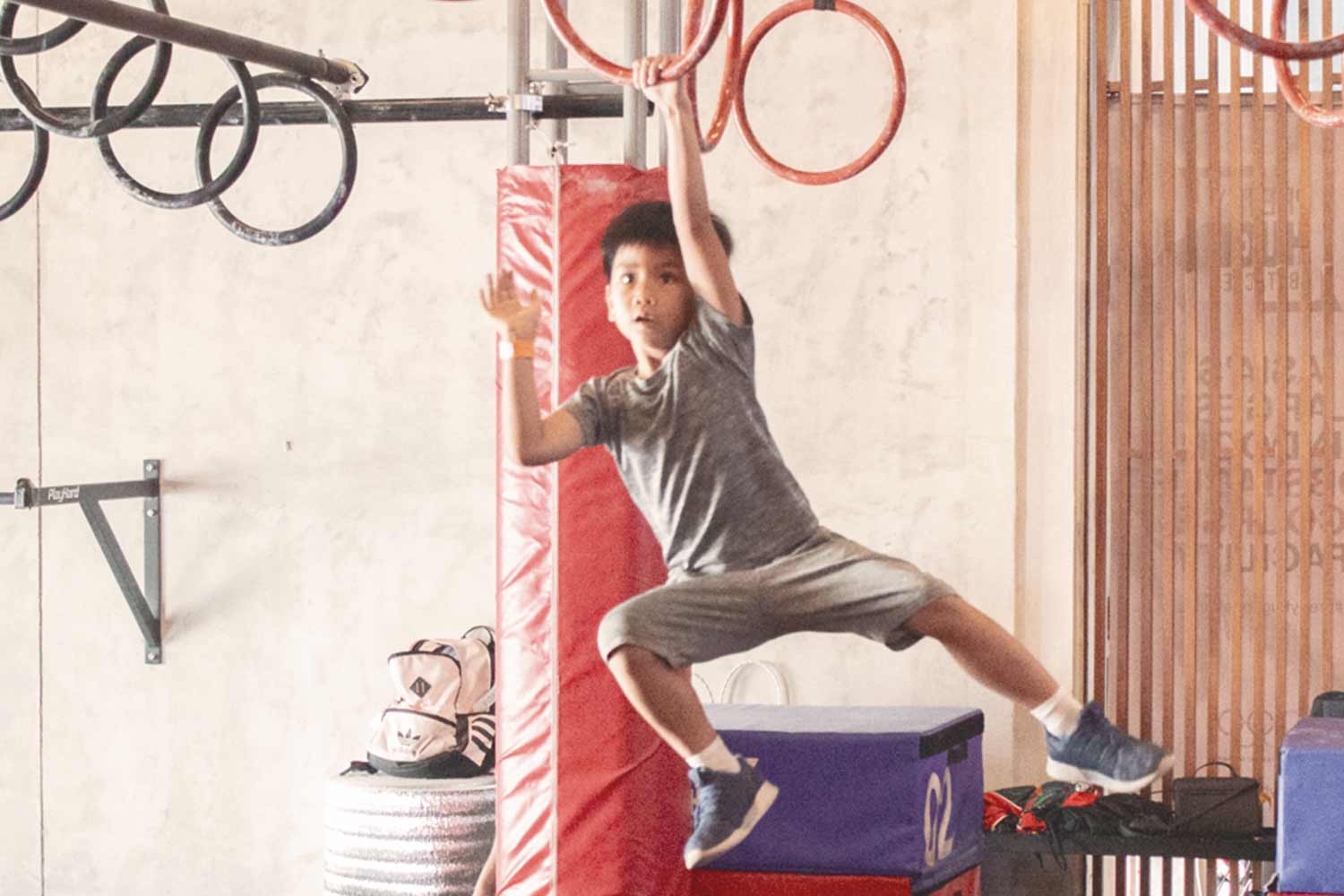 OCR Training Tips for Kids - Boy swinging on rings at PHO