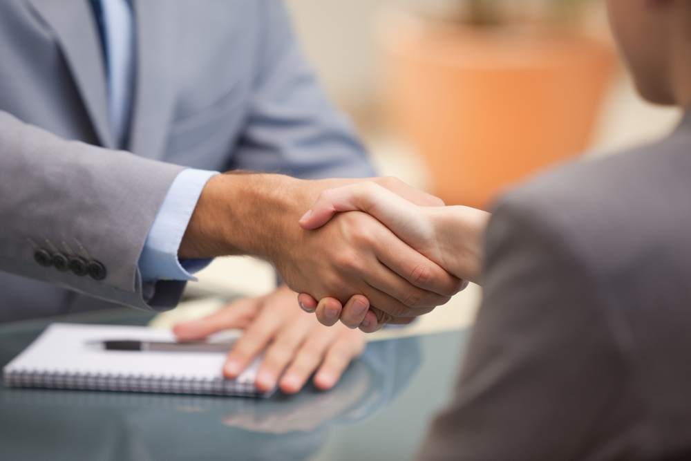 Two Businesspeople shaking hands indoors