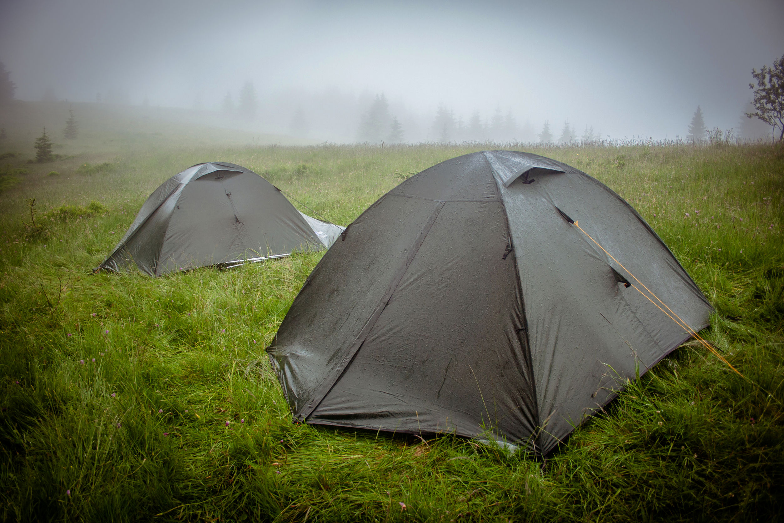 Camping tent within a heavy rain shower and mist
