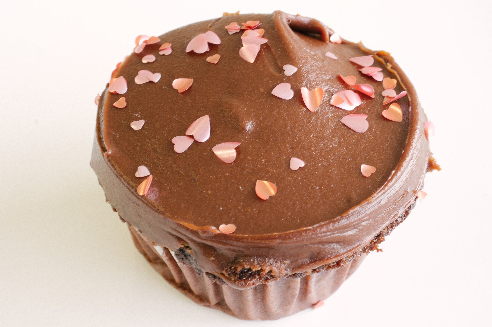 Pink hearts on a cupcake with chocolate frosting