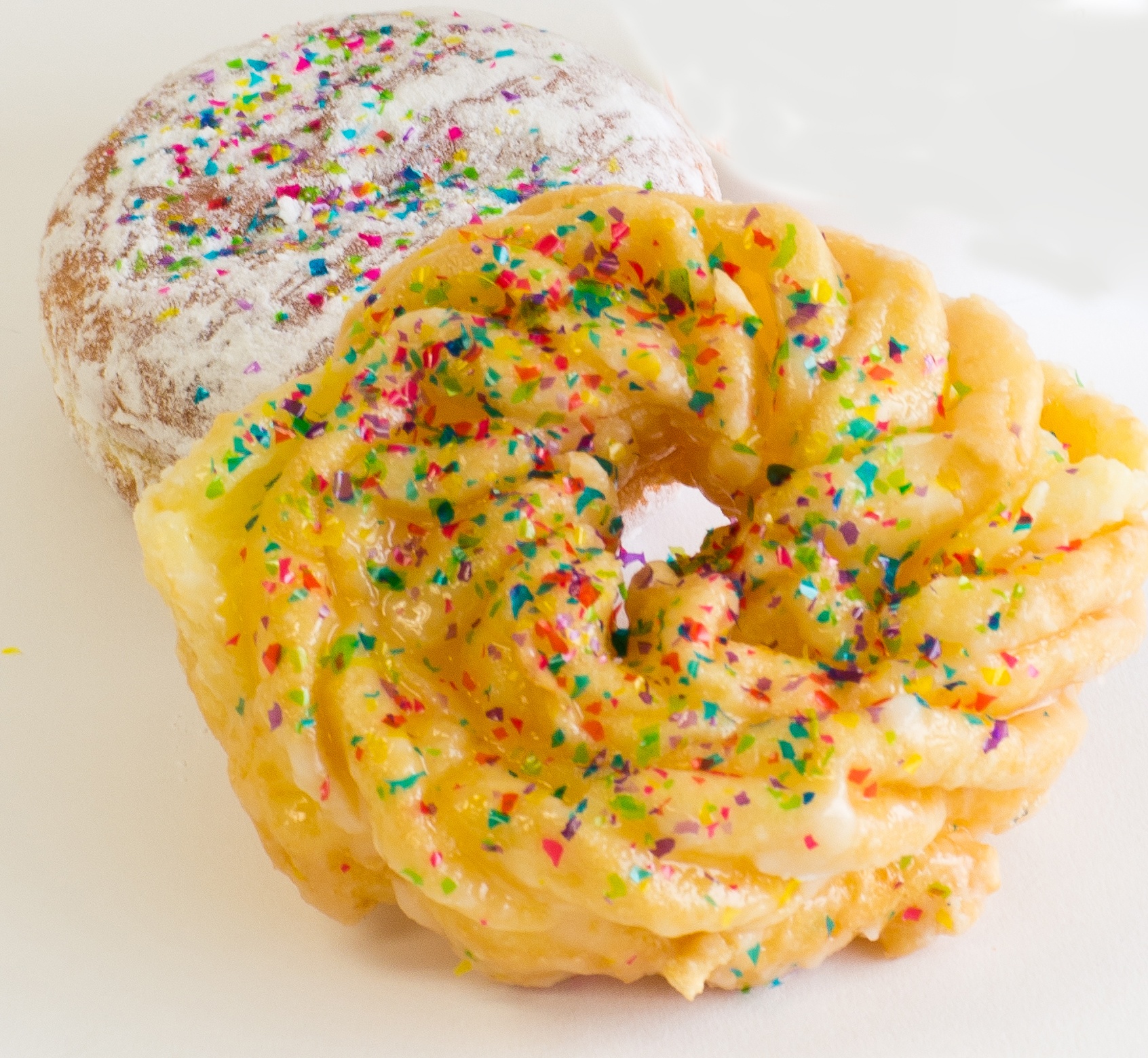 Glazed and powdered donut with carnival edible glitter