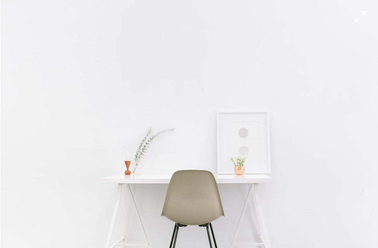 minimalistic desk against a white wall