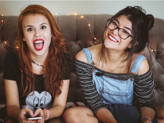 Two_female_students_laughing_revision_personality_type