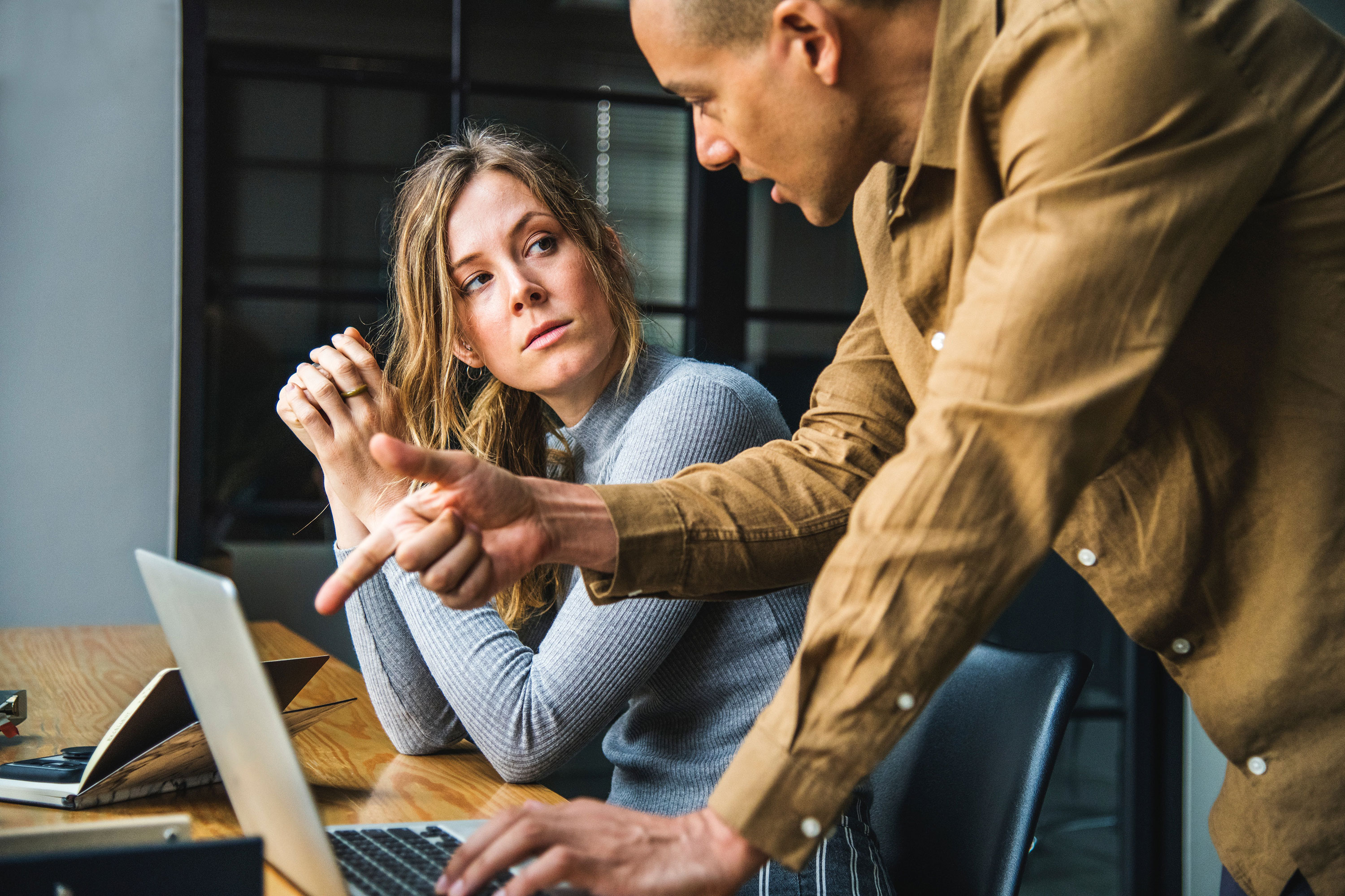 Man and woman at desk with laptop