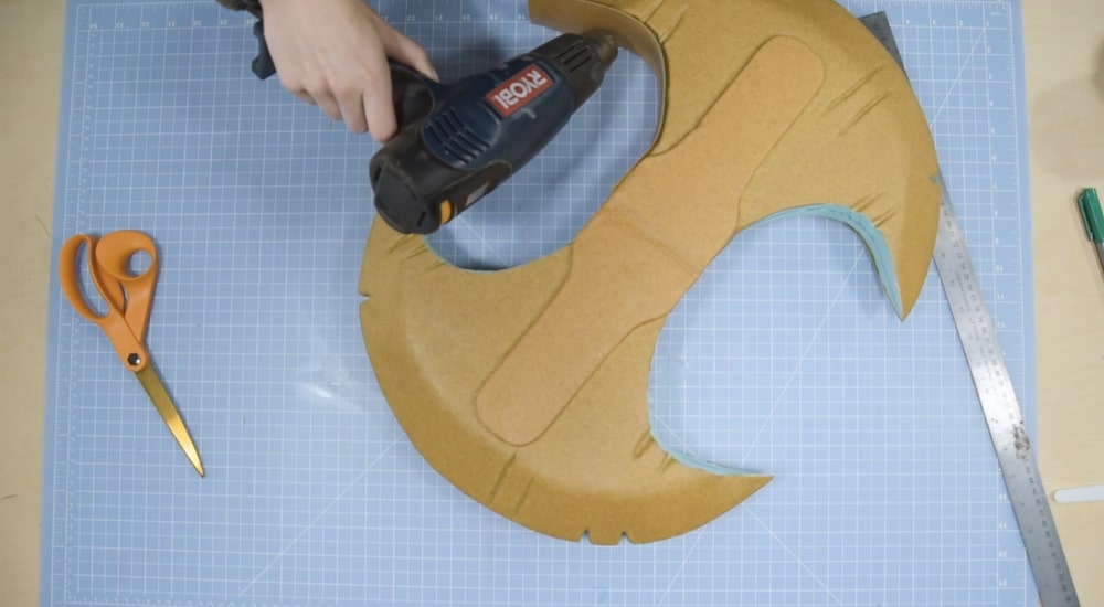 Covering insulation foam axe prop with thermoplastic using a heat gun