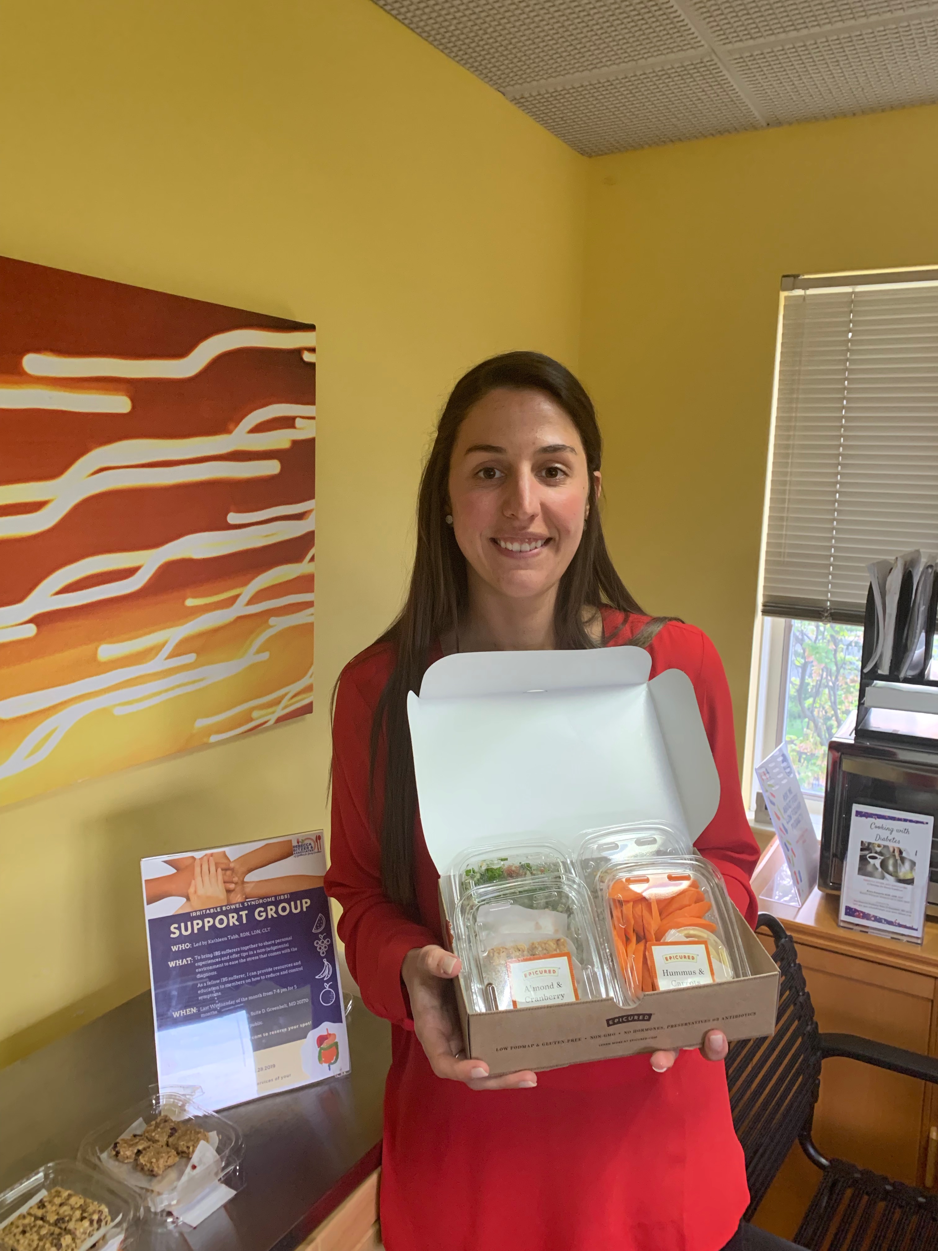 RDN Kathleen Tabb holding box of food.