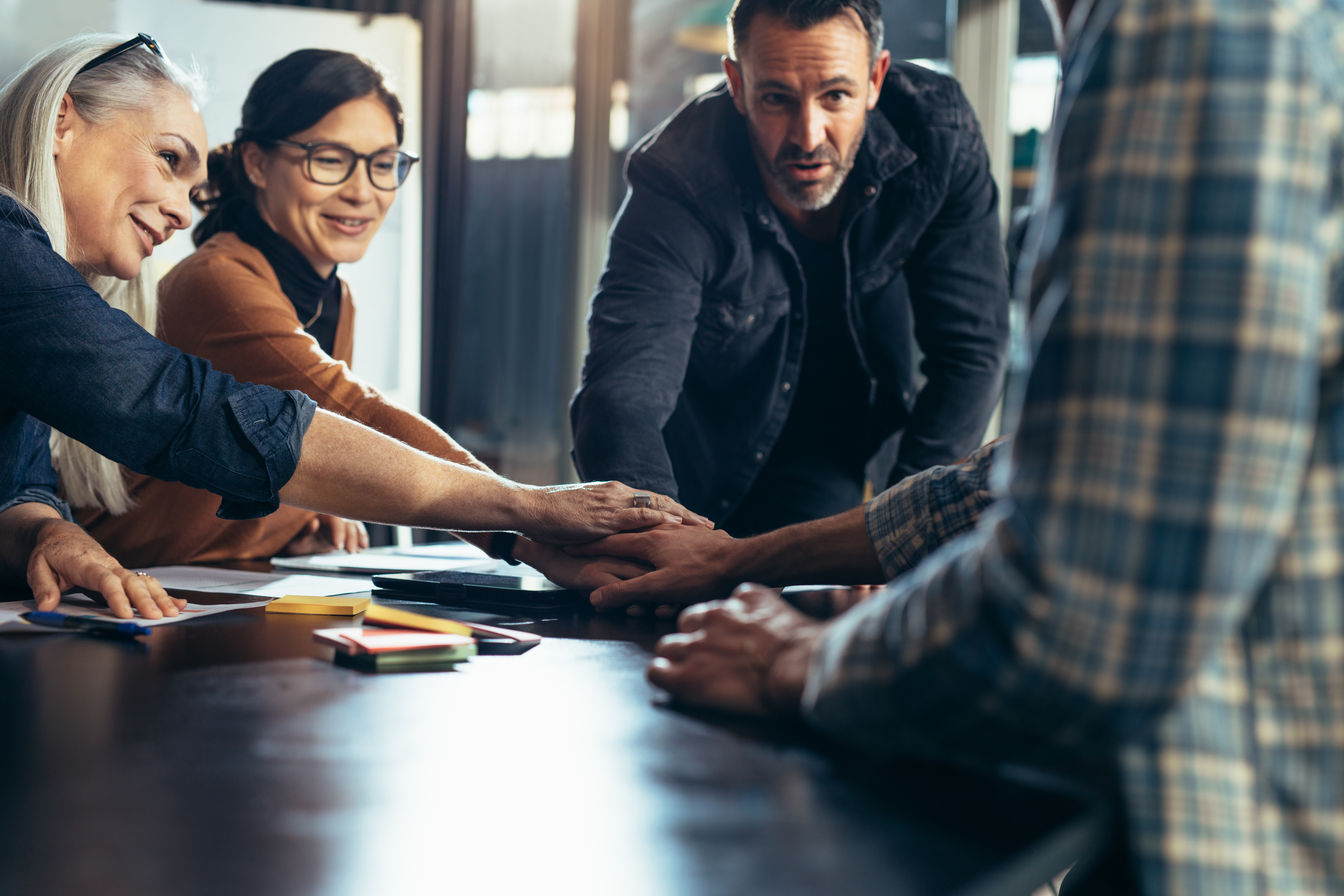 Canva - Team Stacking Hands