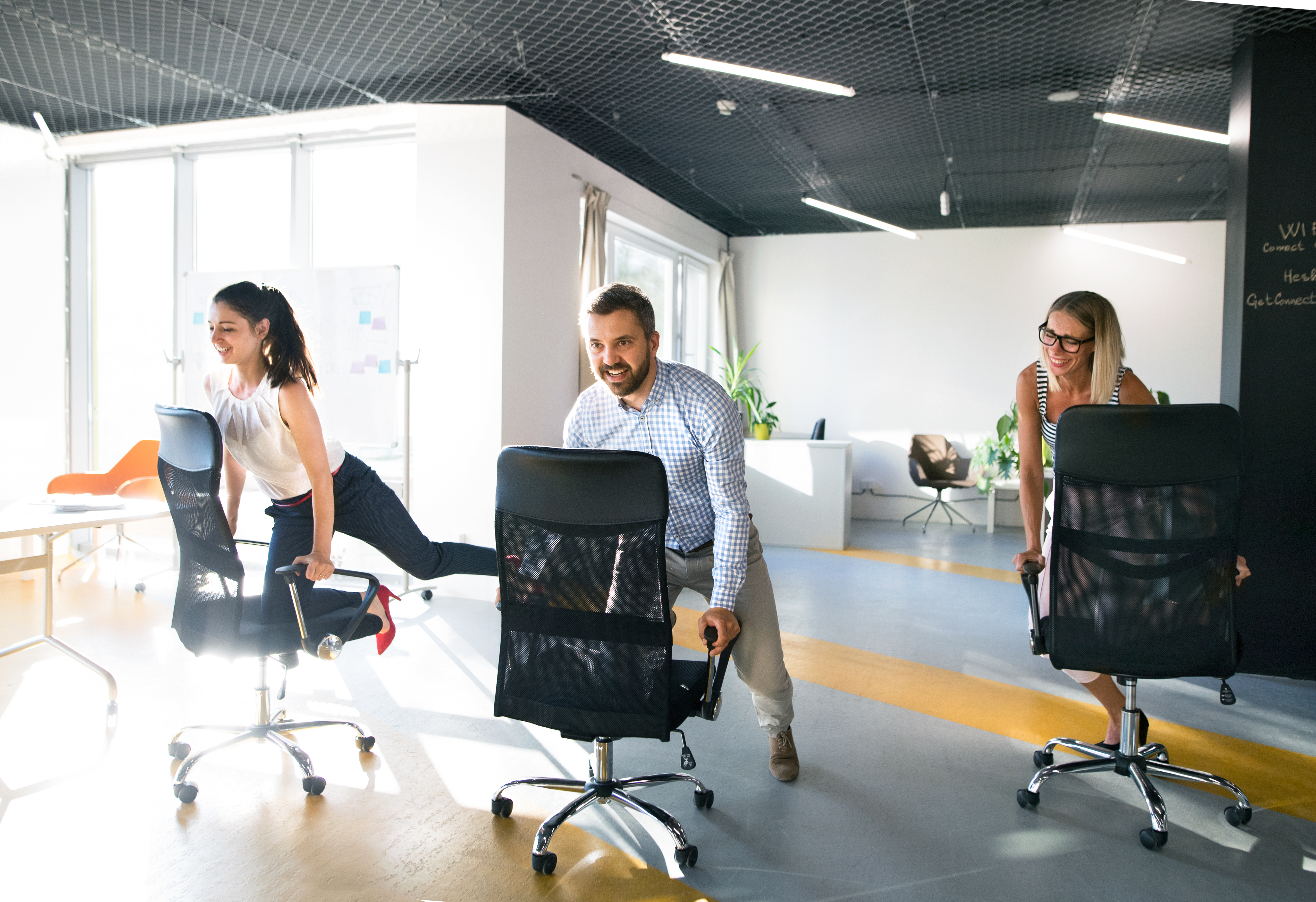 Canva - Business People Riding a Chair and Racing