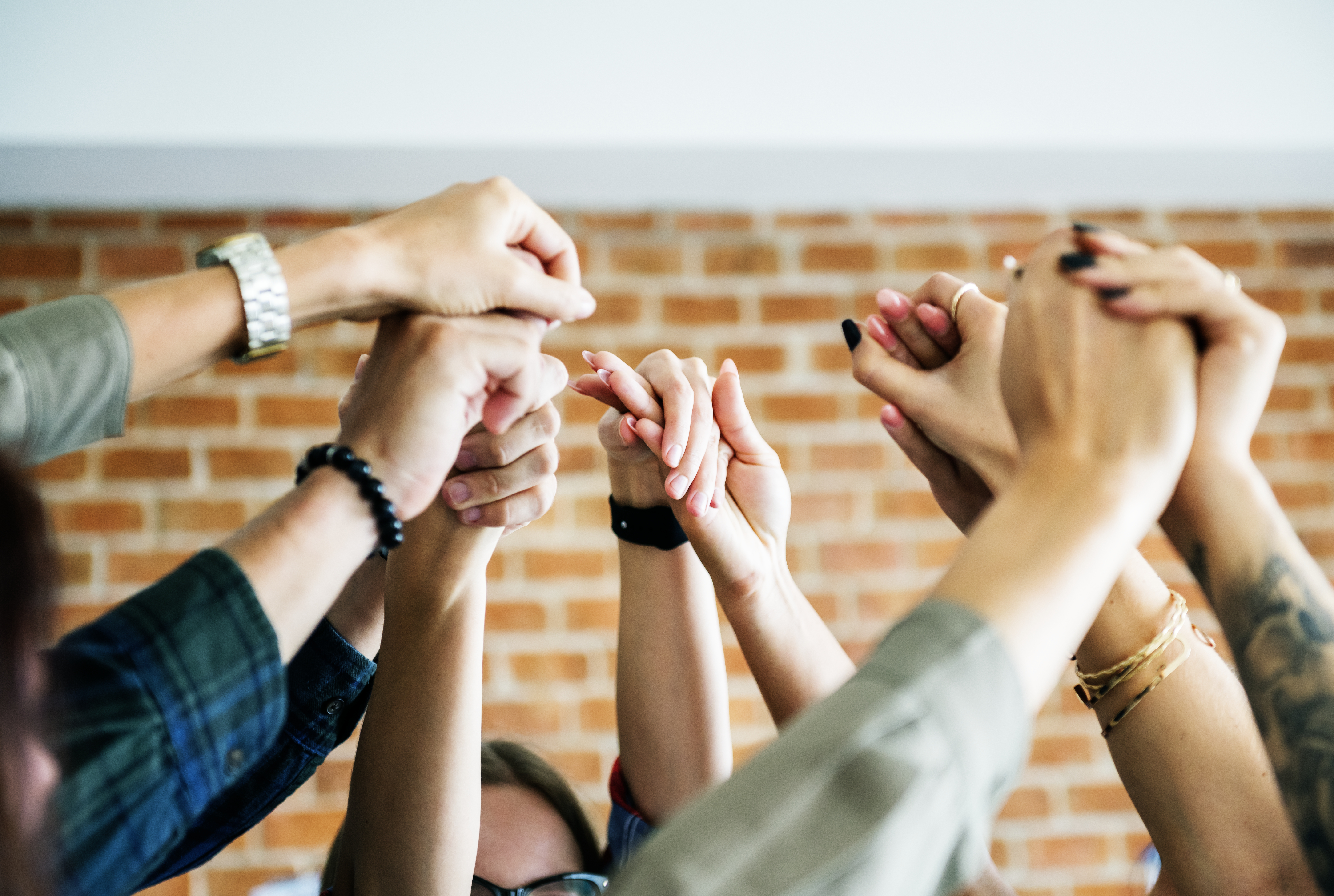 business-team-raising-their-hands-up-to-celebrate-GLXJ8CN