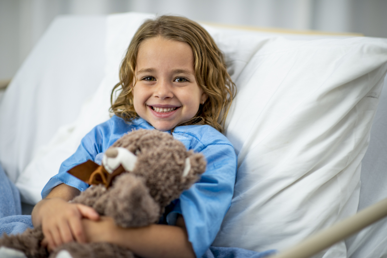 little-girl-in-hospital-bed-with-teddybear