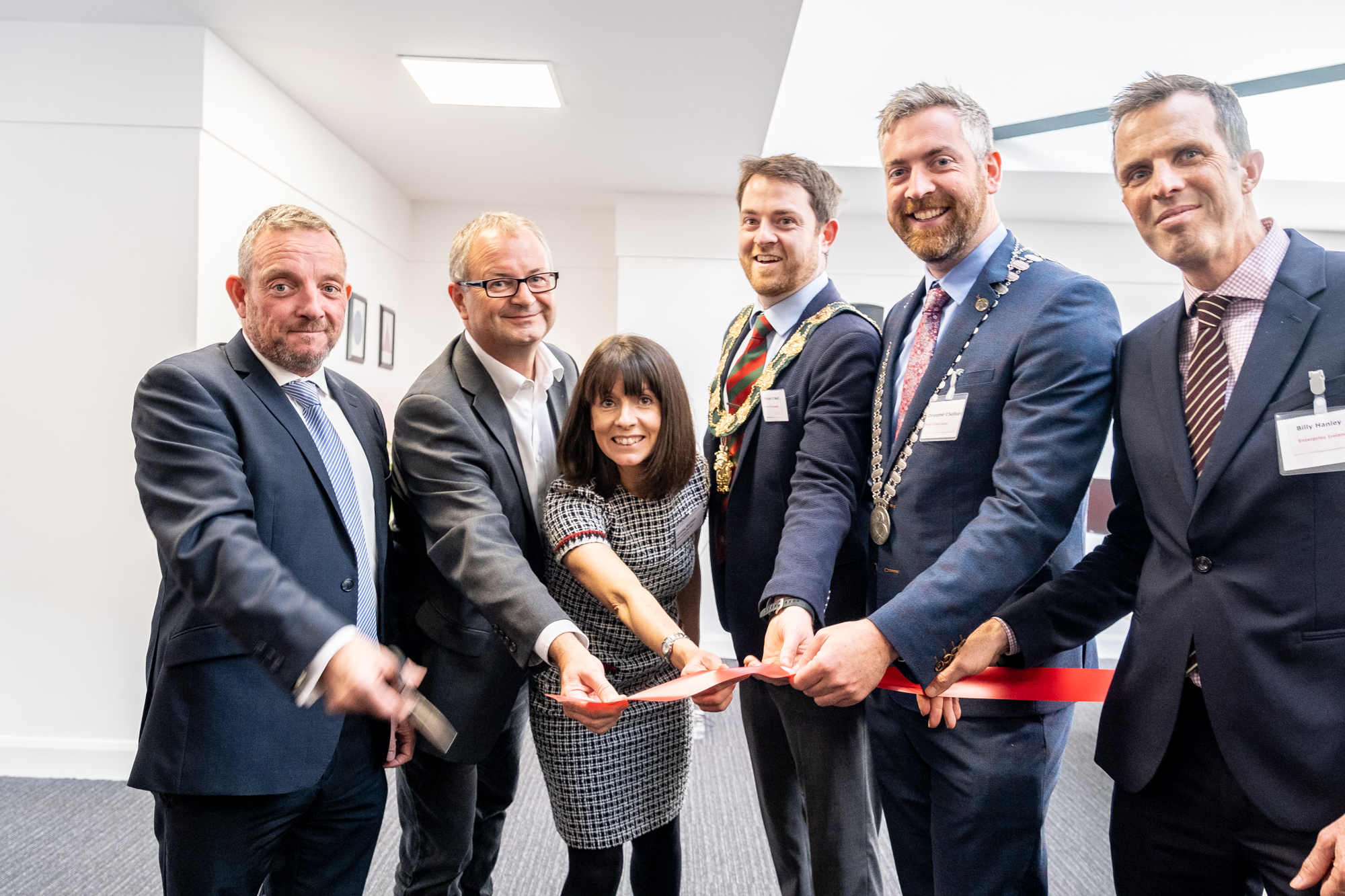 Photo of Global Shares Team cutting the red ribbon for the inauguration