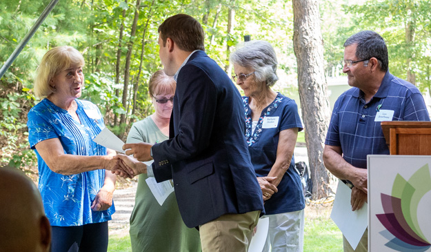 New Hampshire Congressman Chris Pappas congratulates the board members of Riocl Rimmon Cooperative for the successful project.