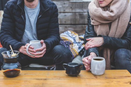 photo of couple holding mugs of coffee - 7 ways to explain anxiety to a partner - genomind