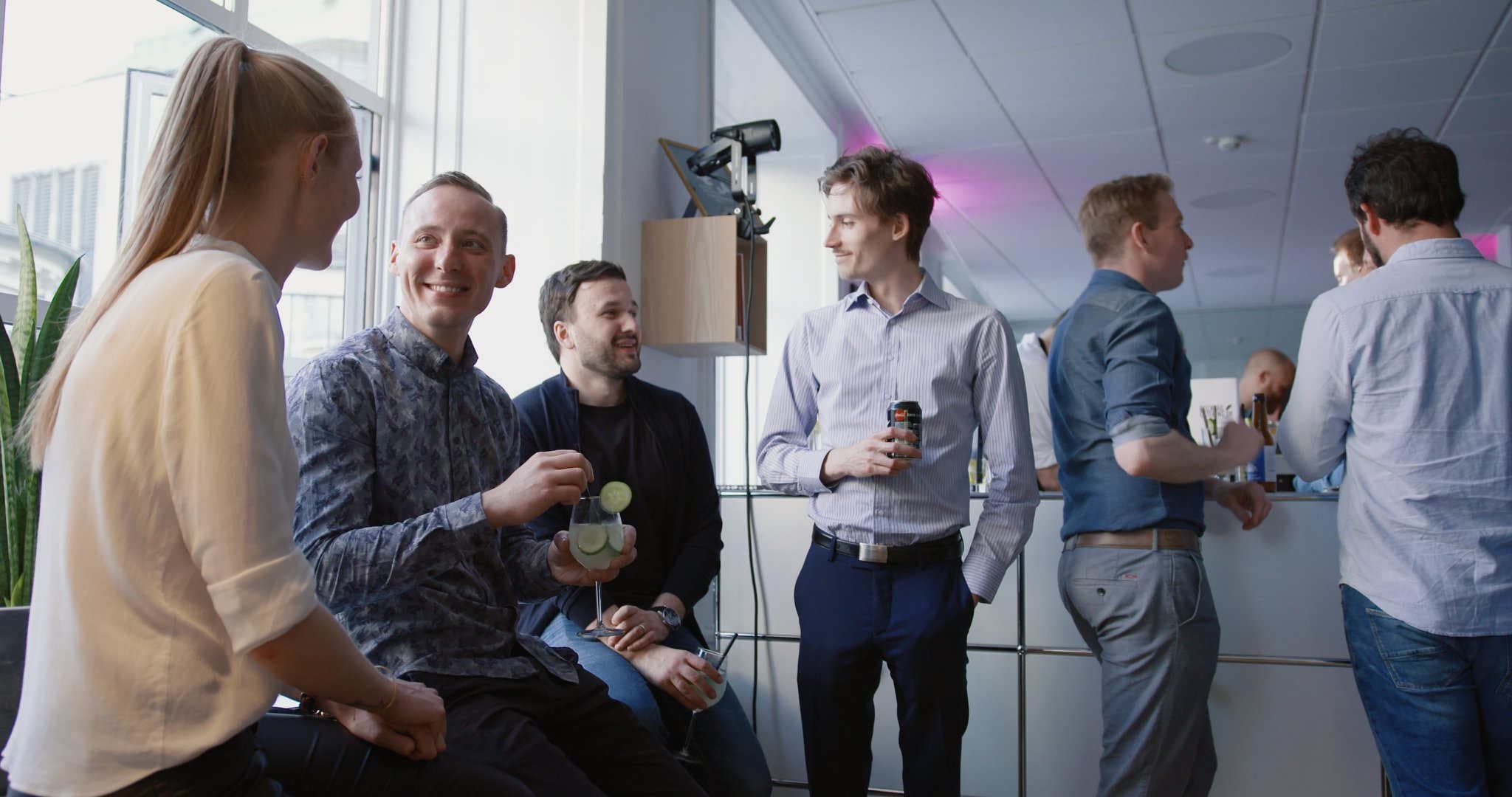 Employees at Templafy holding a drink at the office party