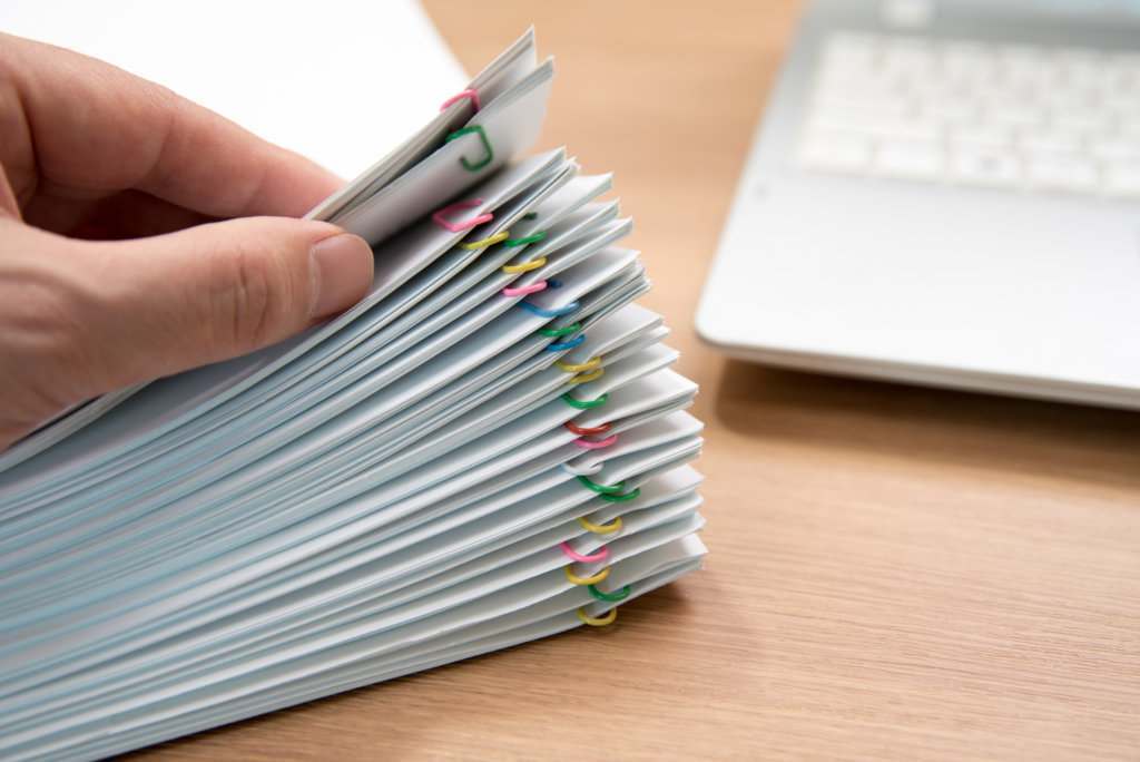 stack of documents on desk