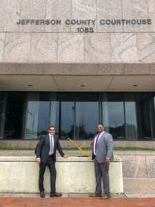 Vuk and Byron outside the courthouse with a model of the crane used in the turnaround job.