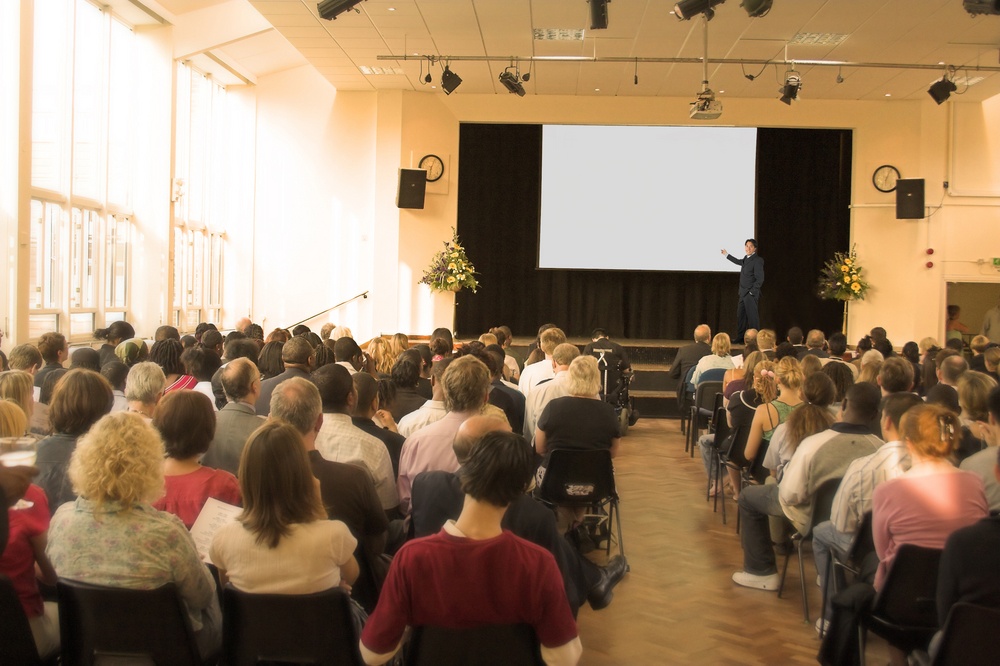 business man giving a conference in a room.jpeg