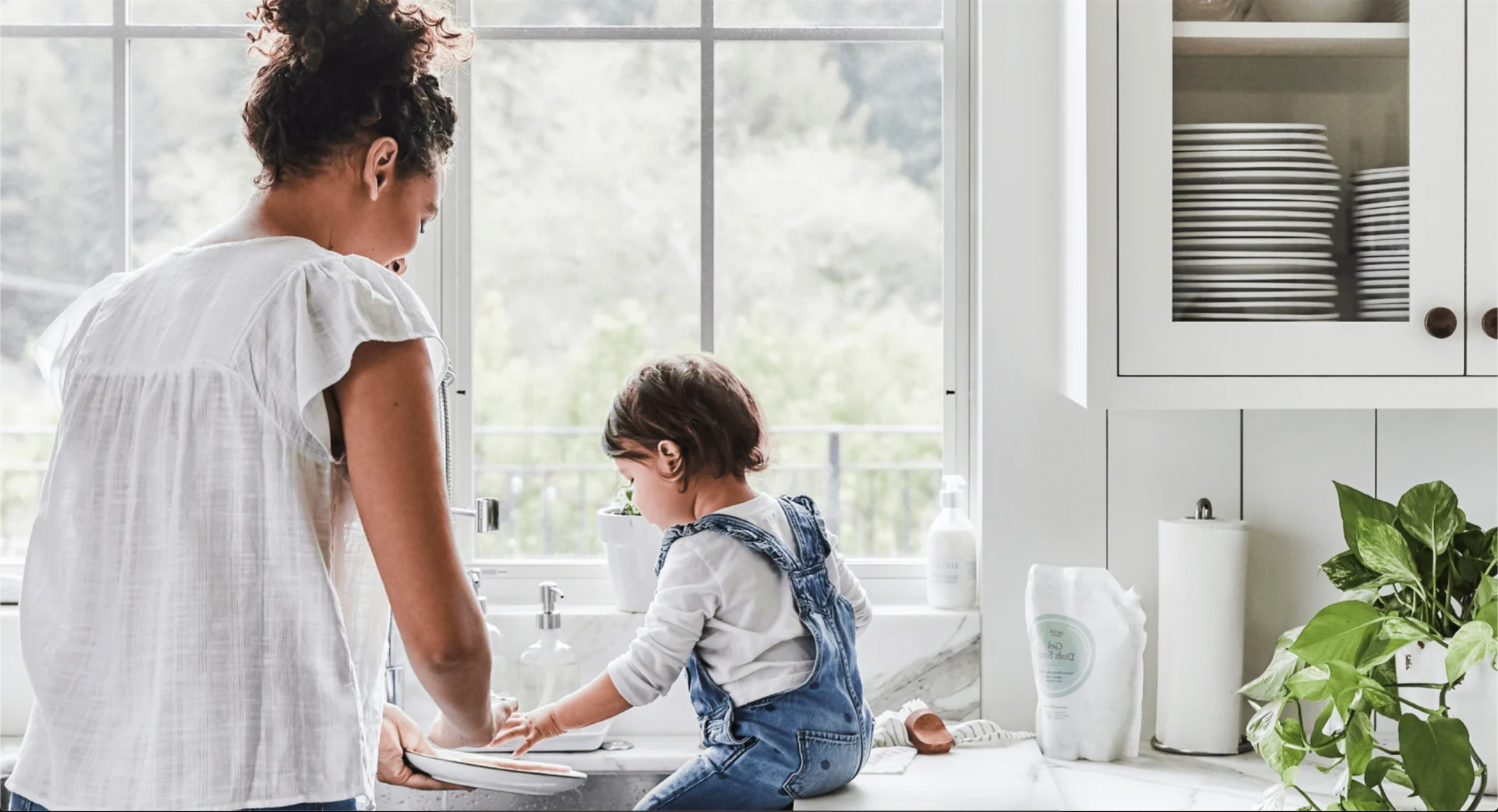 Mother and child washing dishes