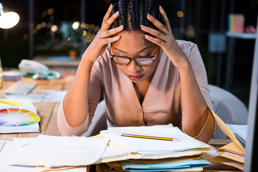 Stressed businesswoman sitting at her desk in the office