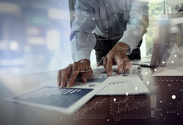 close up of businessman hand working on laptop computer with financial business graph information diagram on wooden desk as concept-908850-edited.jpeg