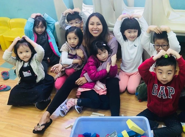 an English teacher in Taiwan in her classroom with her TEFL students