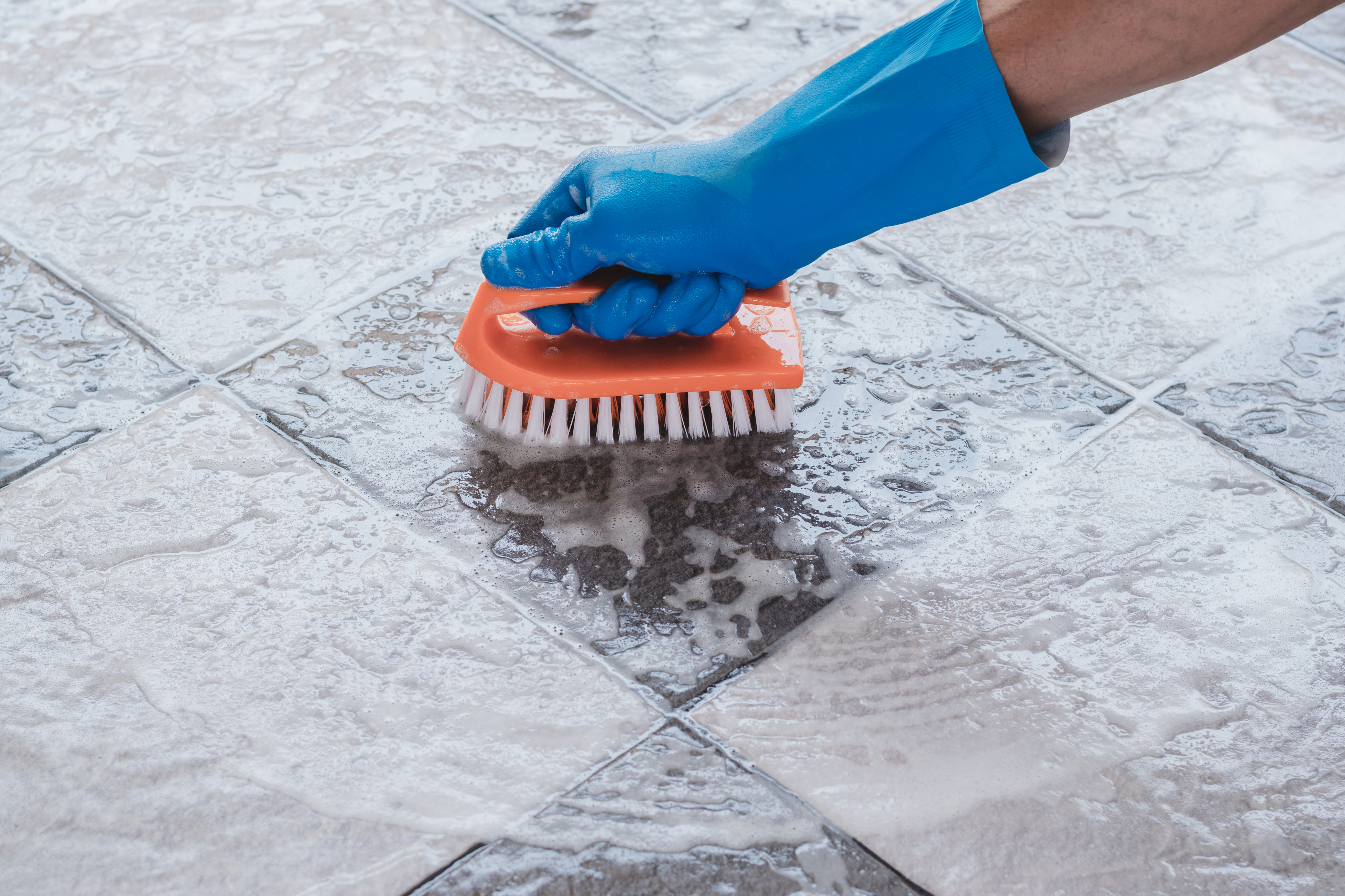 Wire brush to remove store grout from tile