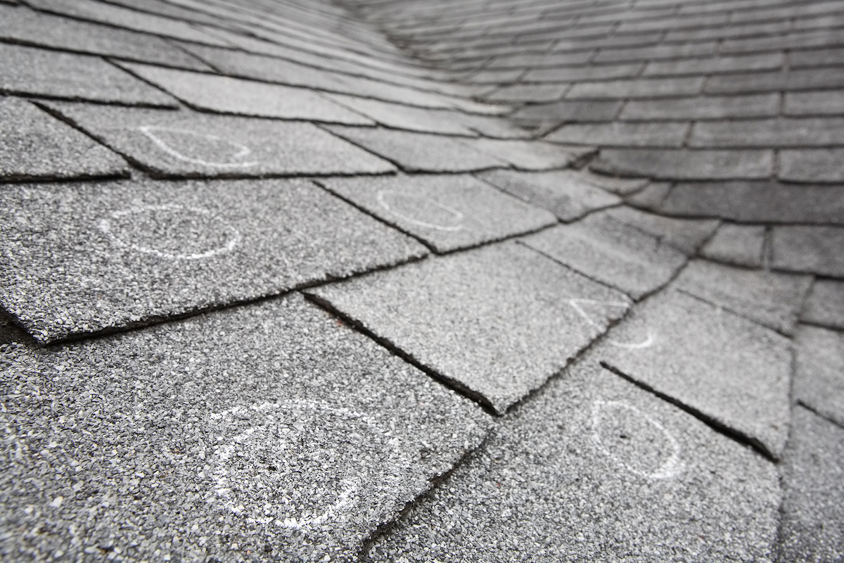 bigstock-Old-roof-with-hail-damage-cha-16442648
