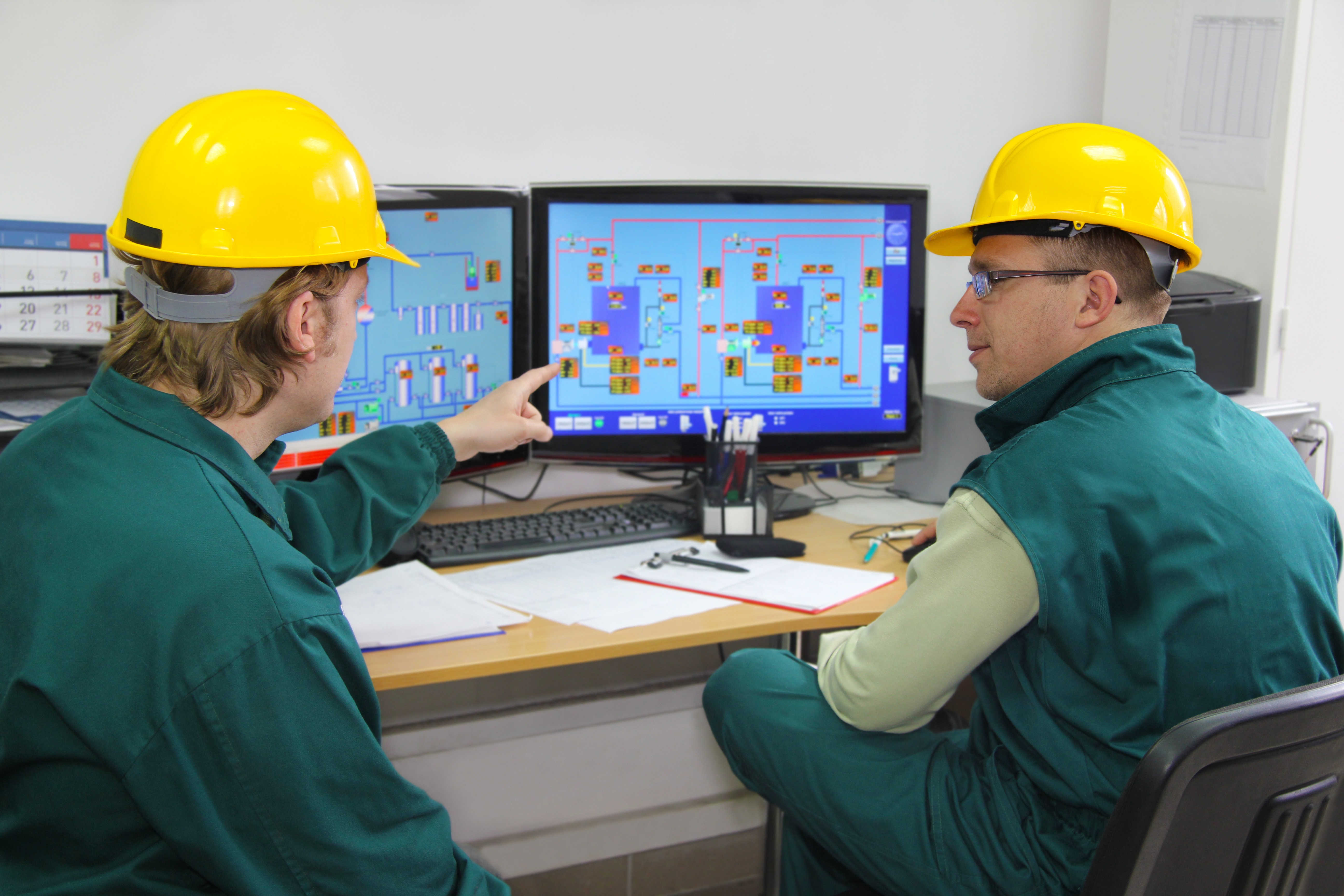 IoT Advances 2 shutterstock_100515940Two workers in hard hats monitor internet of things sensor networks in a manufacturing setting